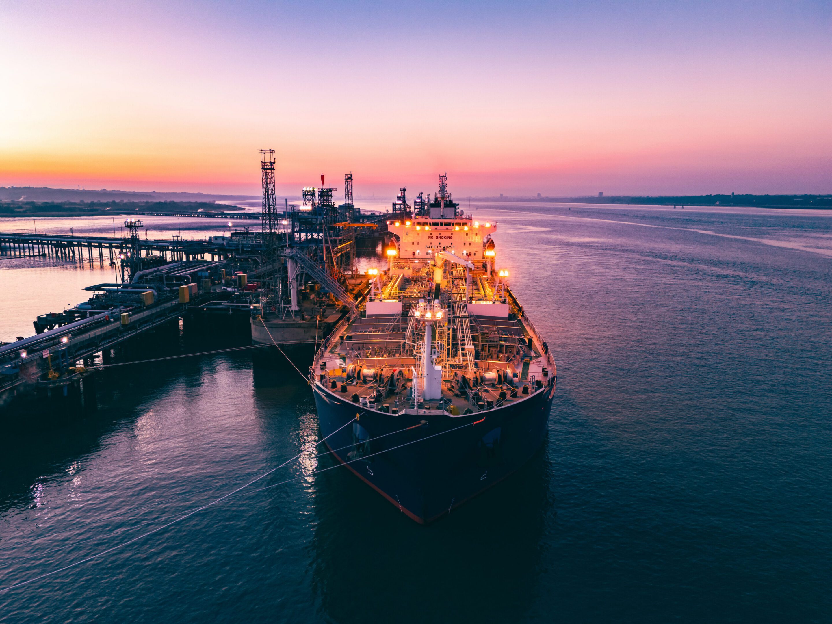 Oil tanker moored at fawley refinery at sunset, southampton, uk